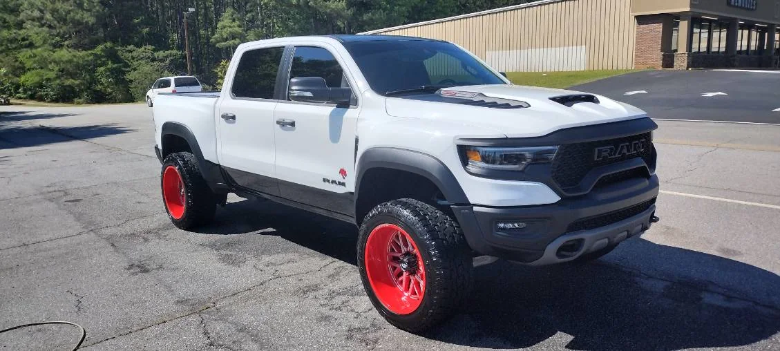 White Ram 1500 TRX on red wheels, washed and finished by Grindtime Mobile Detailing