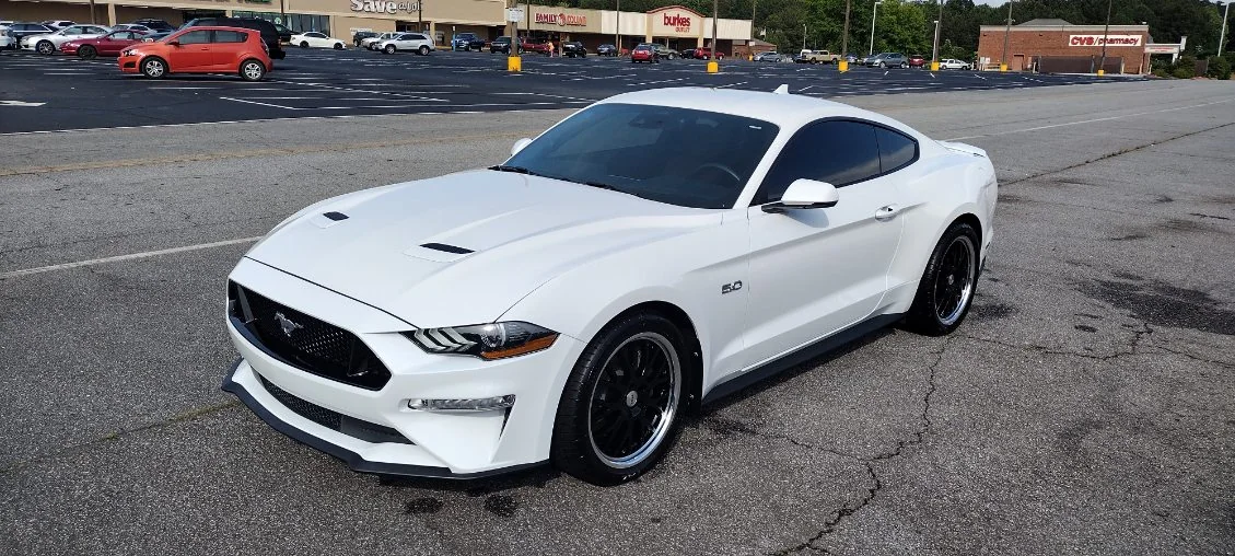 White Ford Mustang GT on black wheels detailed by Grindtime